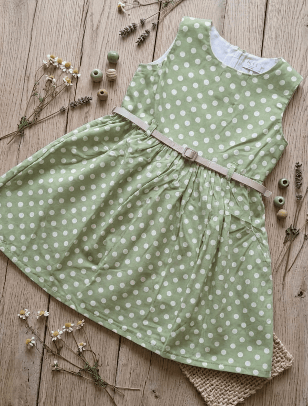 whisperingpoppers summer frocks Floral Cotton Frock with Belt — Vintage Style Girls 1y to 6 Years .polkadot green and white vintage frock .flat lay detail pic.round neckline.sleevless. knee length  with silver belt .front view of the frock.perfect for hot summer days in pakistan.wear it on all day long  gatherings.event lunch and dinner.breathable comfortable fabric.imported