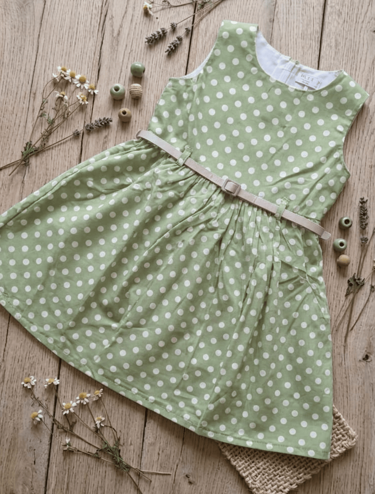 whisperingpoppers summer frocks Floral Cotton Frock with Belt — Vintage Style Girls 1y to 6 Years .polkadot green and white vintage frock .flat lay detail pic.round neckline.sleevless. knee length  with silver belt .front view of the frock.perfect for hot summer days in pakistan.wear it on all day long  gatherings.event lunch and dinner.breathable comfortable fabric.imported
