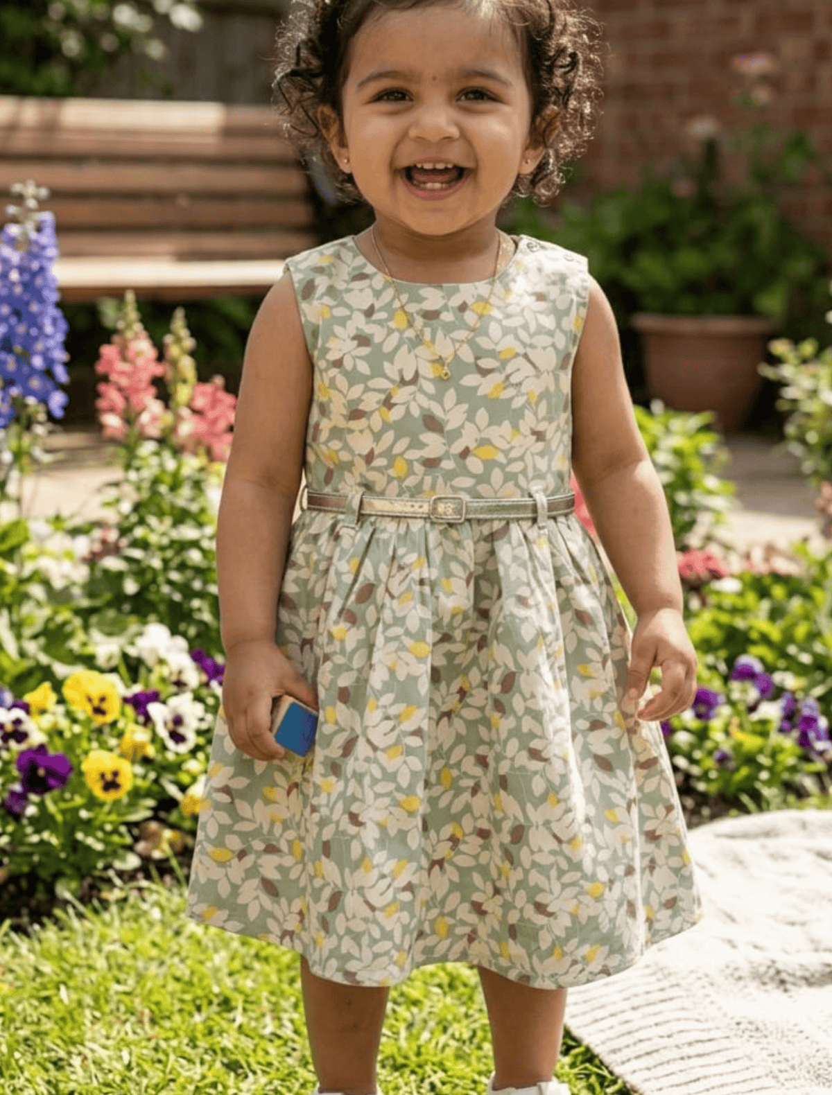 whisperingpoppers summer frock Vintage Style Floral Cotton Frock with Belt — Girls 1y to 6 Years   age .girl is wearng knee lentgth.comfortable  breathable fabric perfect in hot summer sunny days of pakistan.stylish and modren desgin.sleevles.  sage green colour patrren 