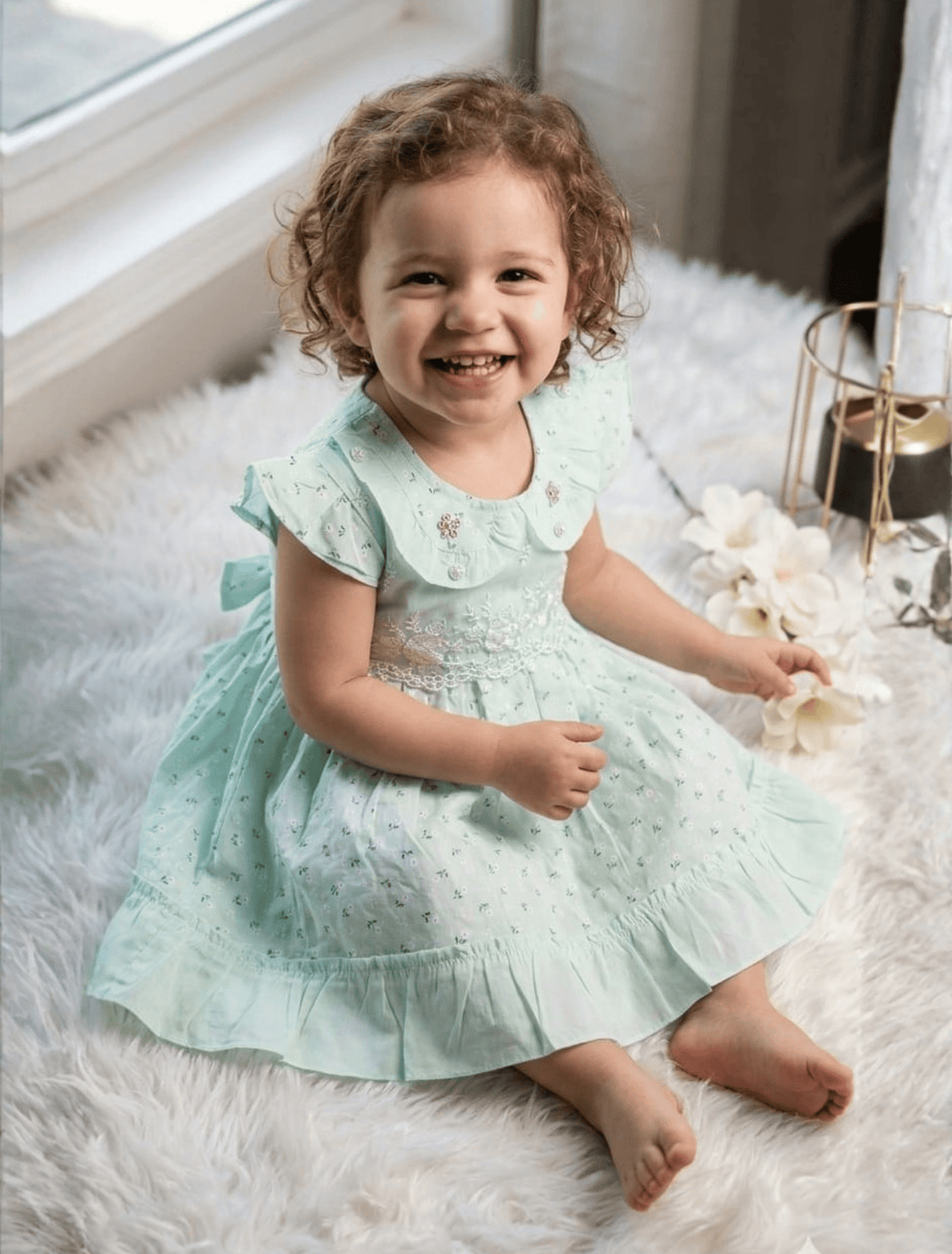 whisperingpoppers summer frocks pistachio hues lawn frock-Baby girl age 9 month-1.5 year  little girl wearing breathable lawn fabric frock .peterpan coller and embriodered net bodice and lawn printed desgine. frill desgine on end of the frock.beautiful printed fabric. cool in hot summer days of pakistan.belt on back for adjustment and button on back for easy wear